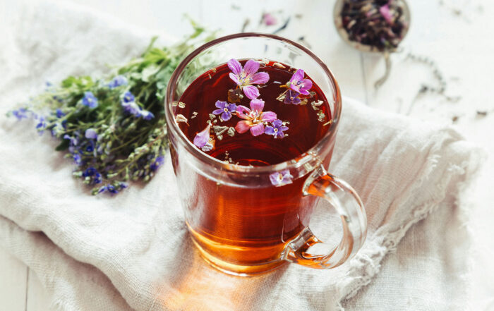 Glass mug of fruit and flower tea